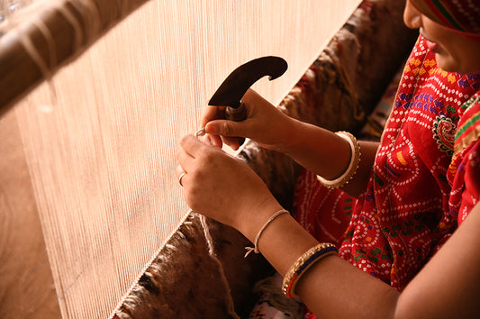 Weaver Weaving a Rug